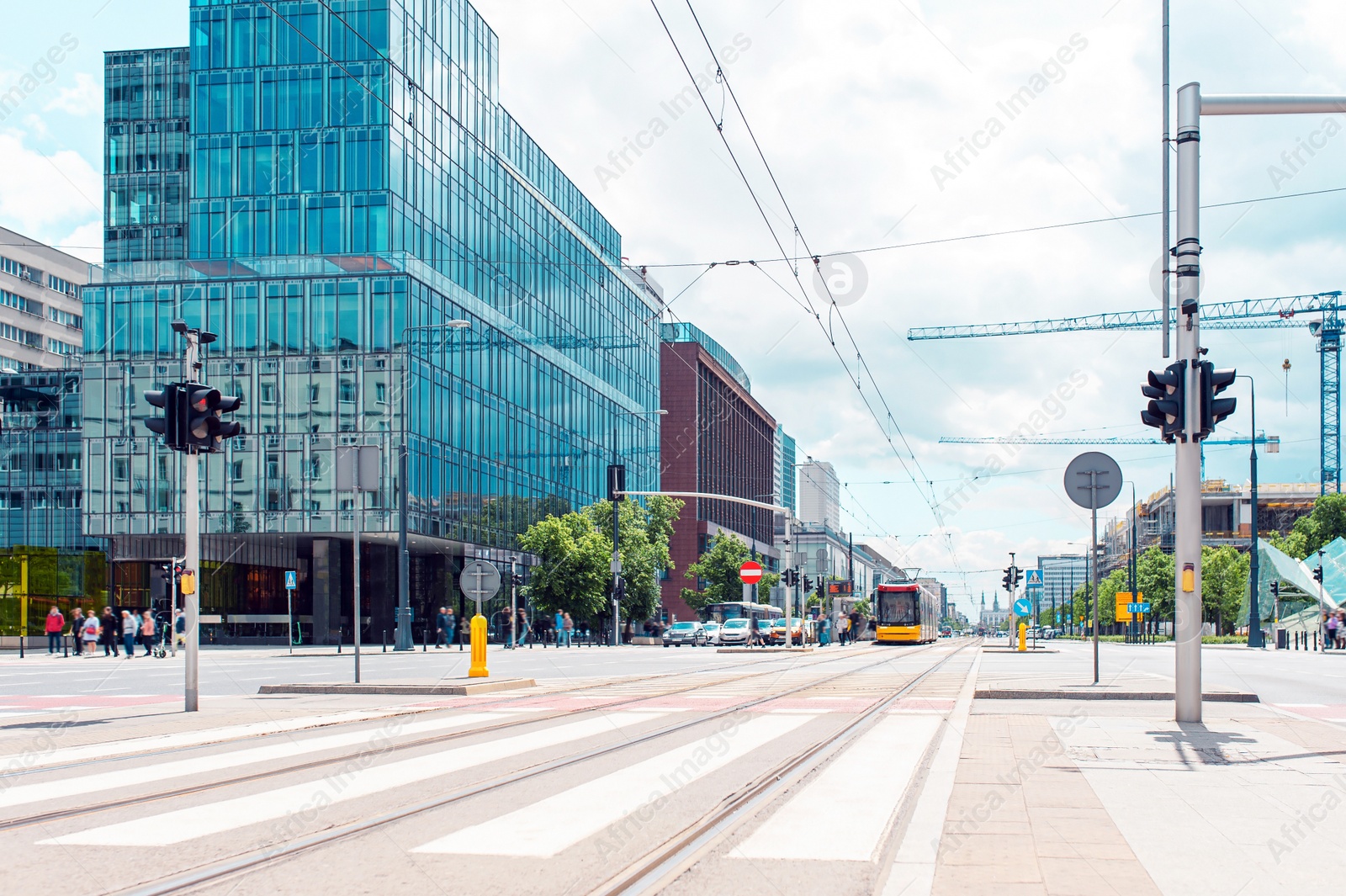 Photo of Road, vehicles and beautiful buildings on cloudy day in city