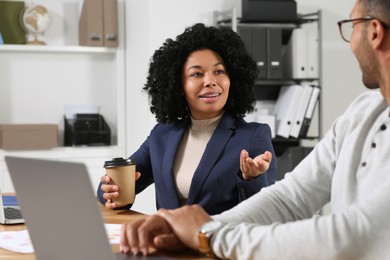 Young colleagues working together at table in office