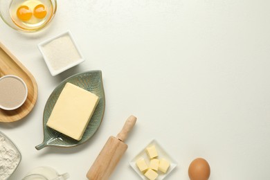 Photo of Flat lay composition with fresh butter among other products on white table. Space for text