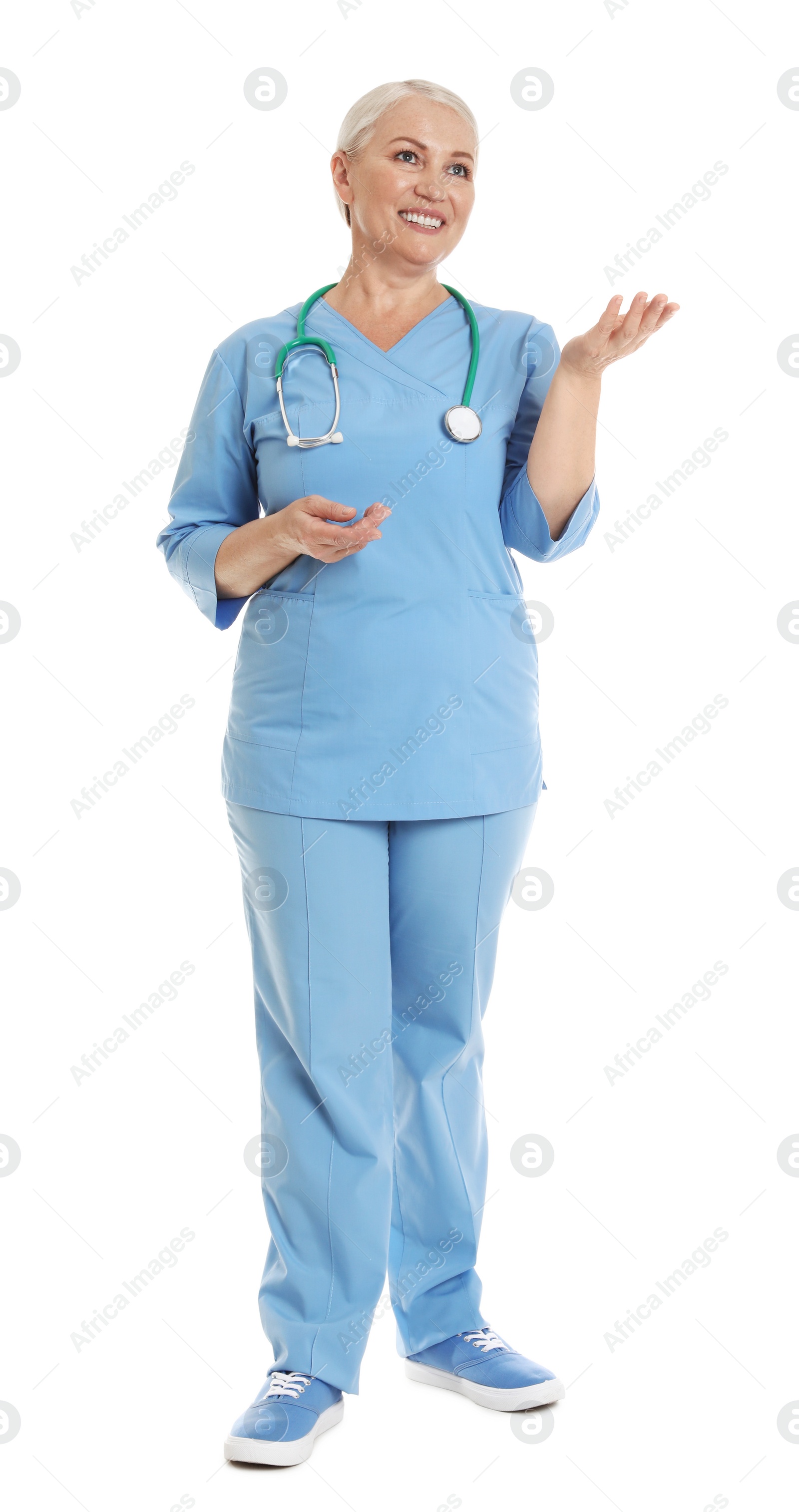 Photo of Full length portrait of female doctor in scrubs isolated on white. Medical staff