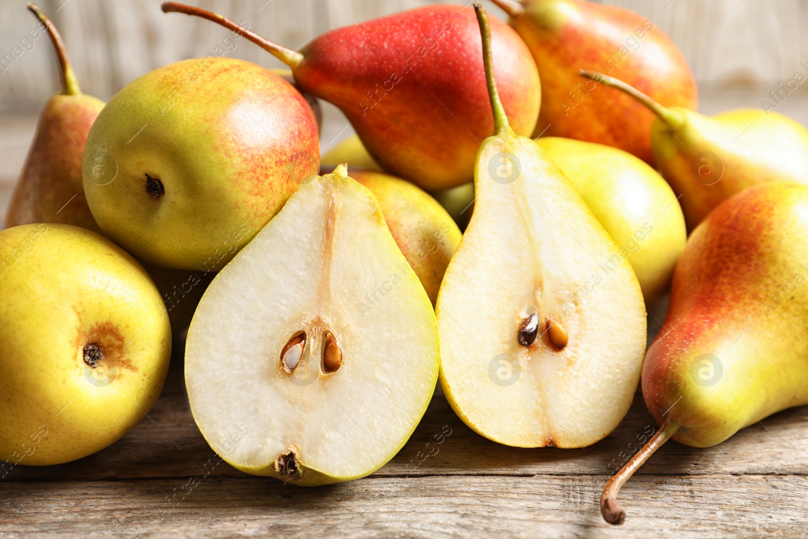 Photo of Ripe pears on wooden table. Healthy snack