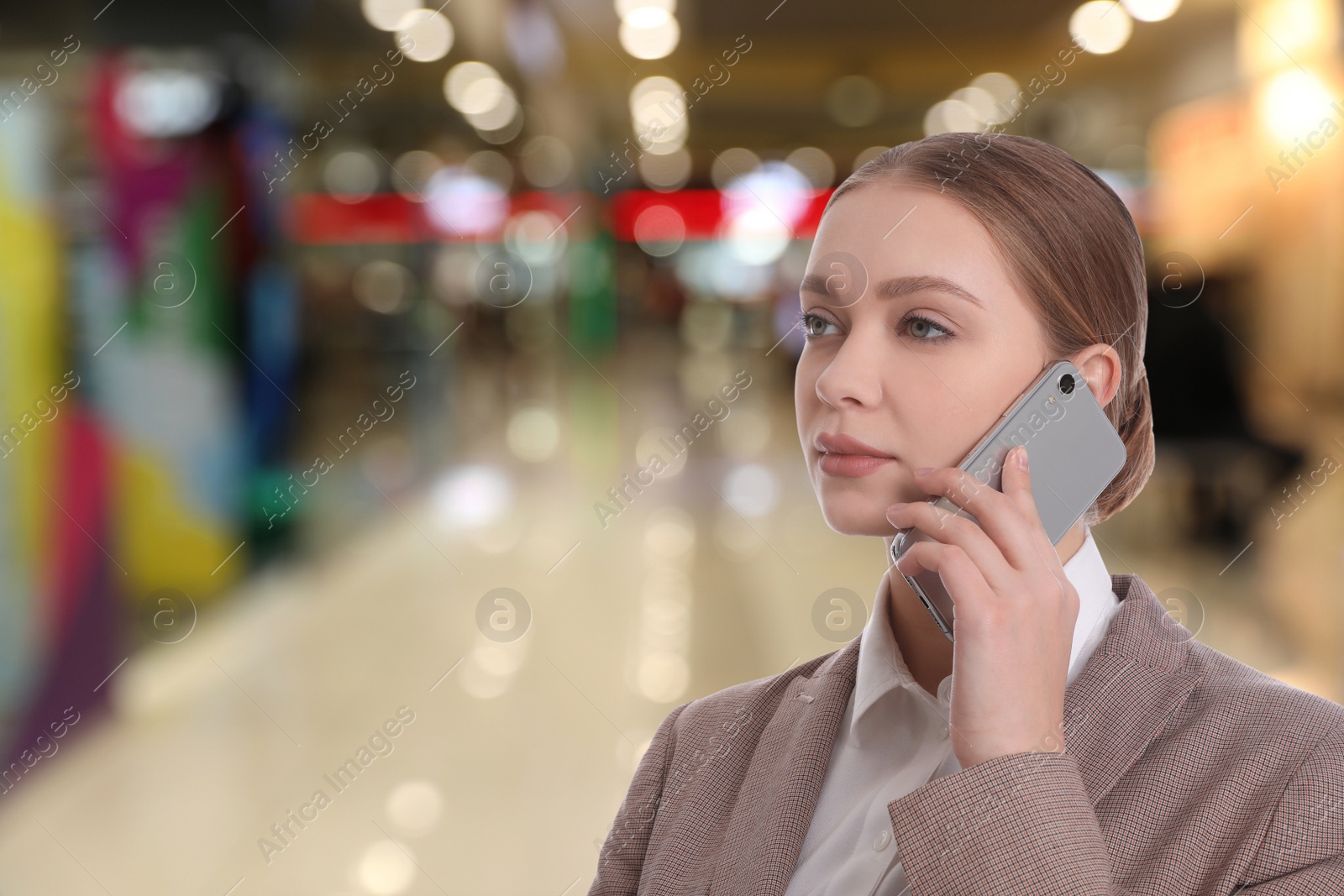 Image of Wholesale and logistics concept. Manager talking on phone in shopping mall