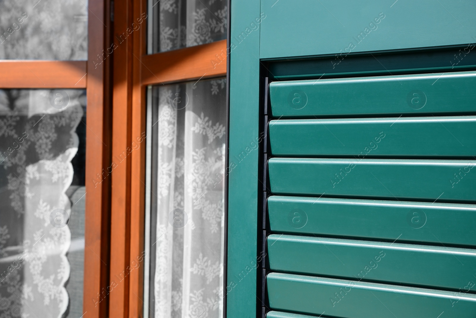 Photo of Window with vintage wooden shutters outdoors, closeup