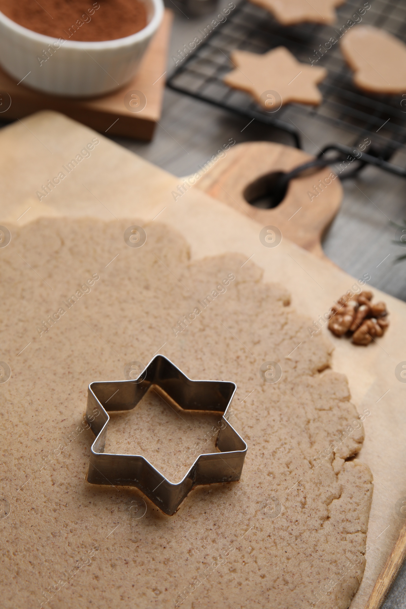 Photo of Homemade Christmas biscuits. Dough and cookie cutter on table, closeup