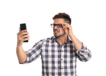 Photo of Young man with vision problems using smartphone on white background