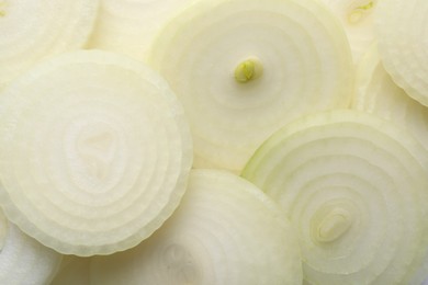 Slices of fresh ripe onion as background, top view