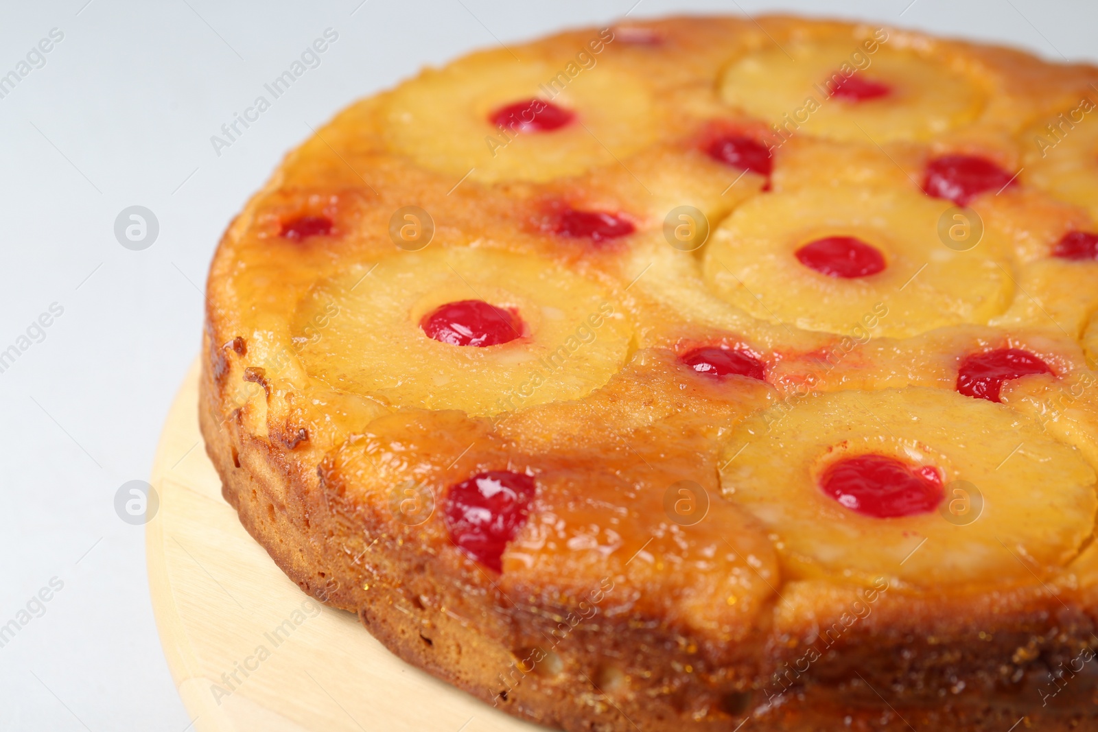 Photo of Tasty pineapple cake with cherries on white background, closeup