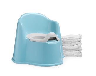 Photo of Light blue baby potty and stack of diapers isolated on white. Toilet training