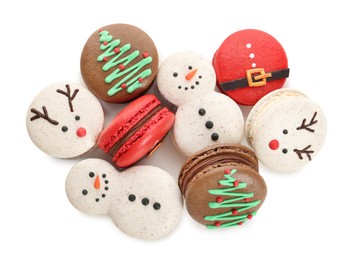 Photo of Beautifully decorated Christmas macarons on white background, top view