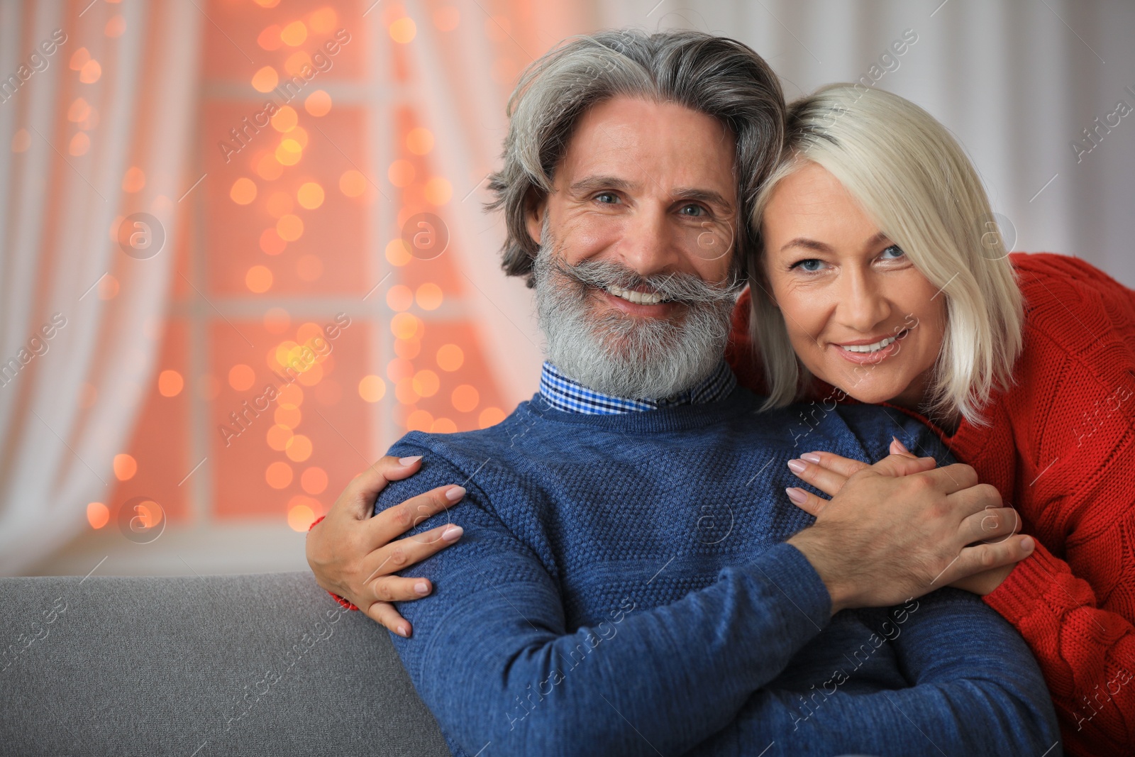 Photo of Happy mature couple celebrating Christmas at home