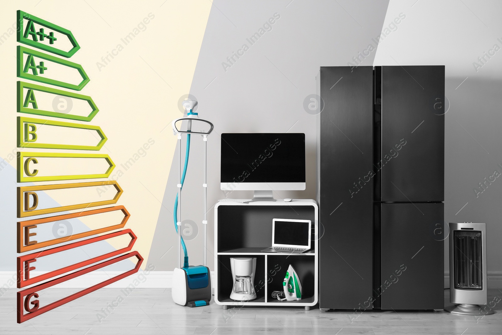 Image of Energy efficiency rating label and different household appliances near color wall indoors