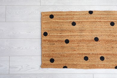 Photo of Stylish rug with dots on floor, top view