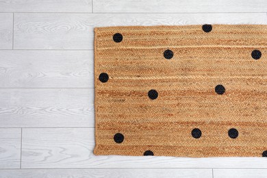 Stylish rug with dots on floor, top view