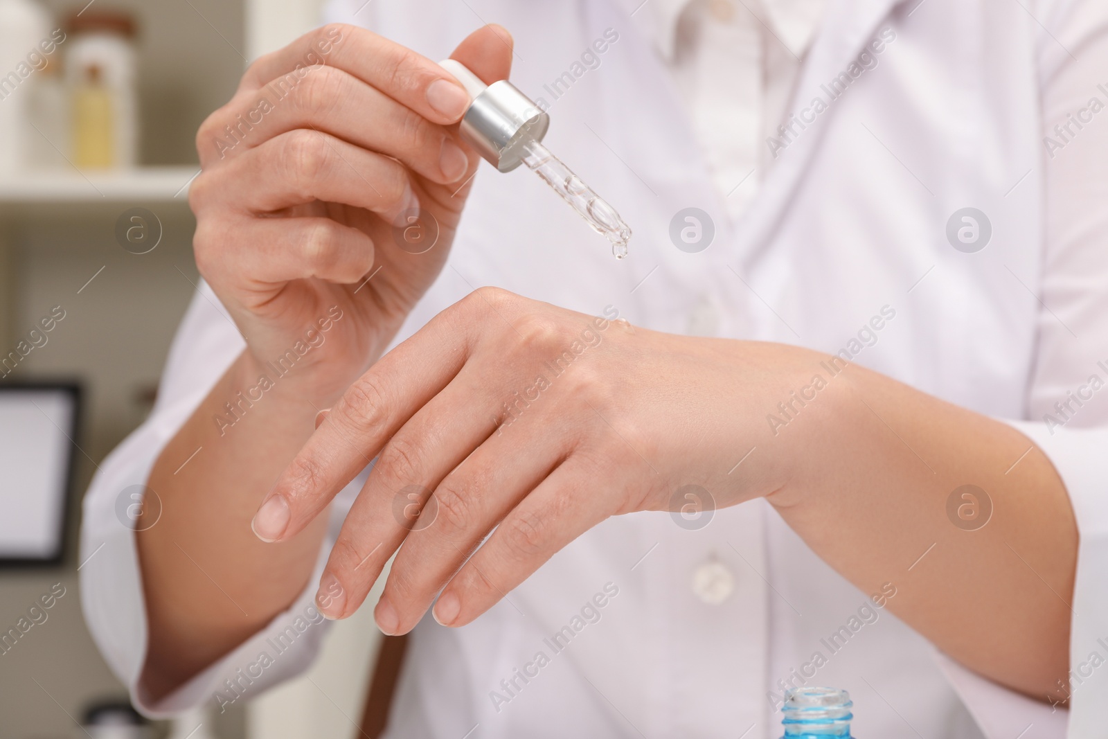 Photo of Dermatologist testing cosmetic product in laboratory, closeup