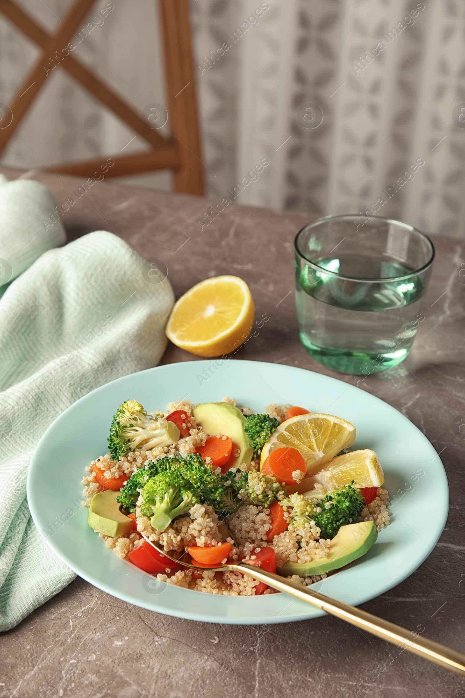 Photo of Salad with quinoa in plate on table