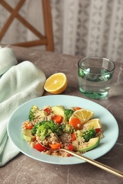 Salad with quinoa in plate on table