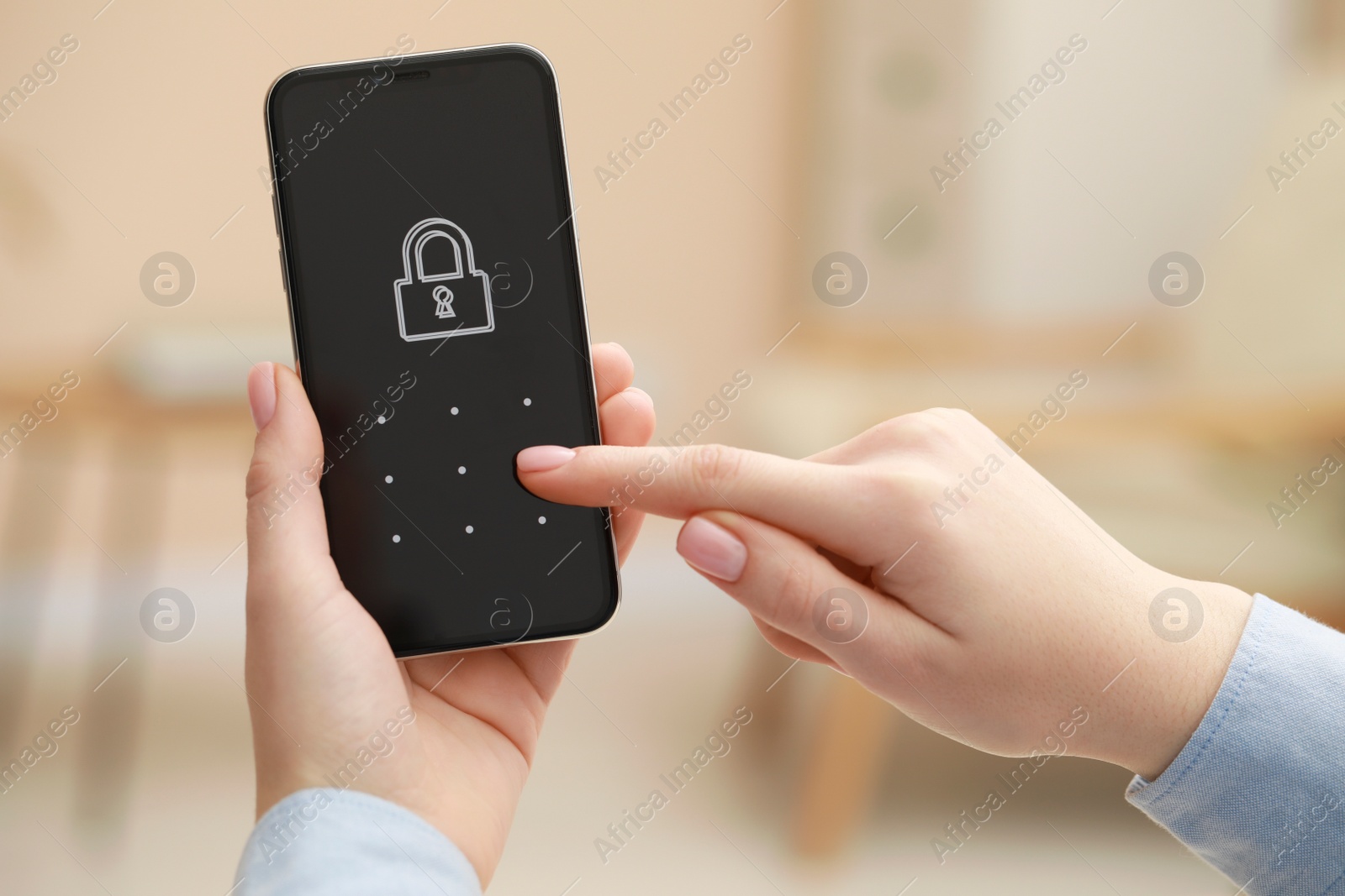 Photo of Woman unlocking smartphone with blocked screen indoors, closeup