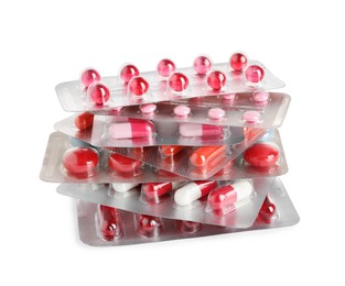 Stack of blisters with different pills on white background