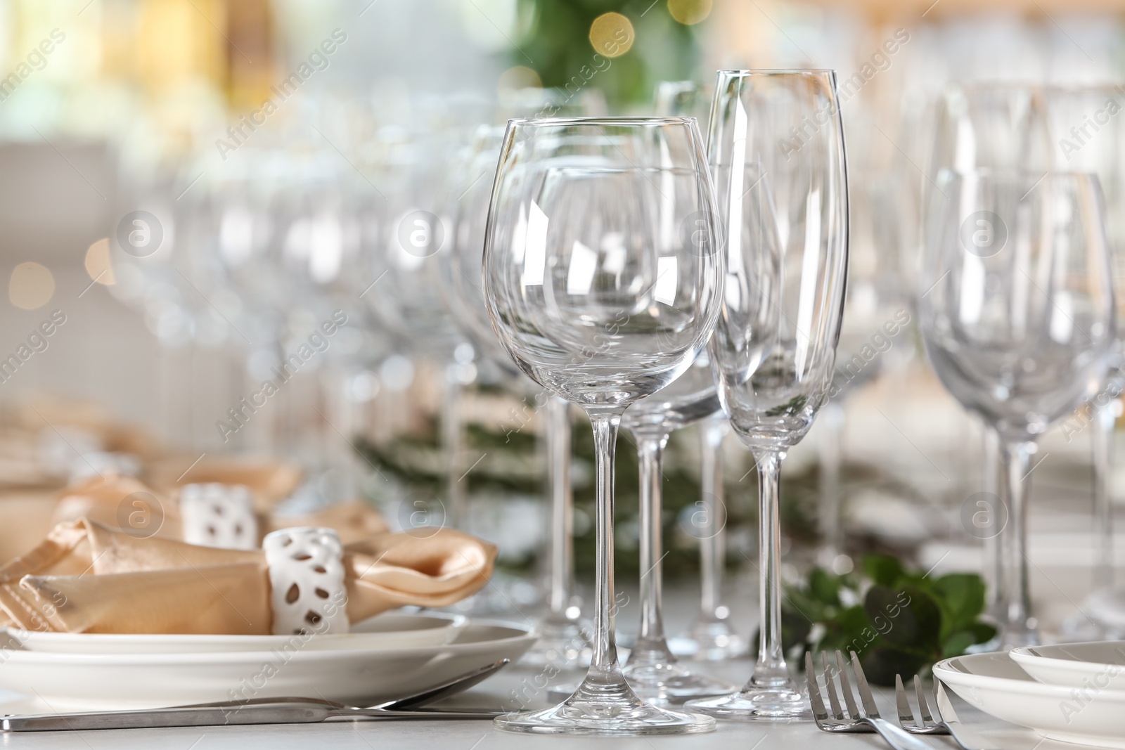 Photo of Table setting with empty glasses, plates and cutlery indoors