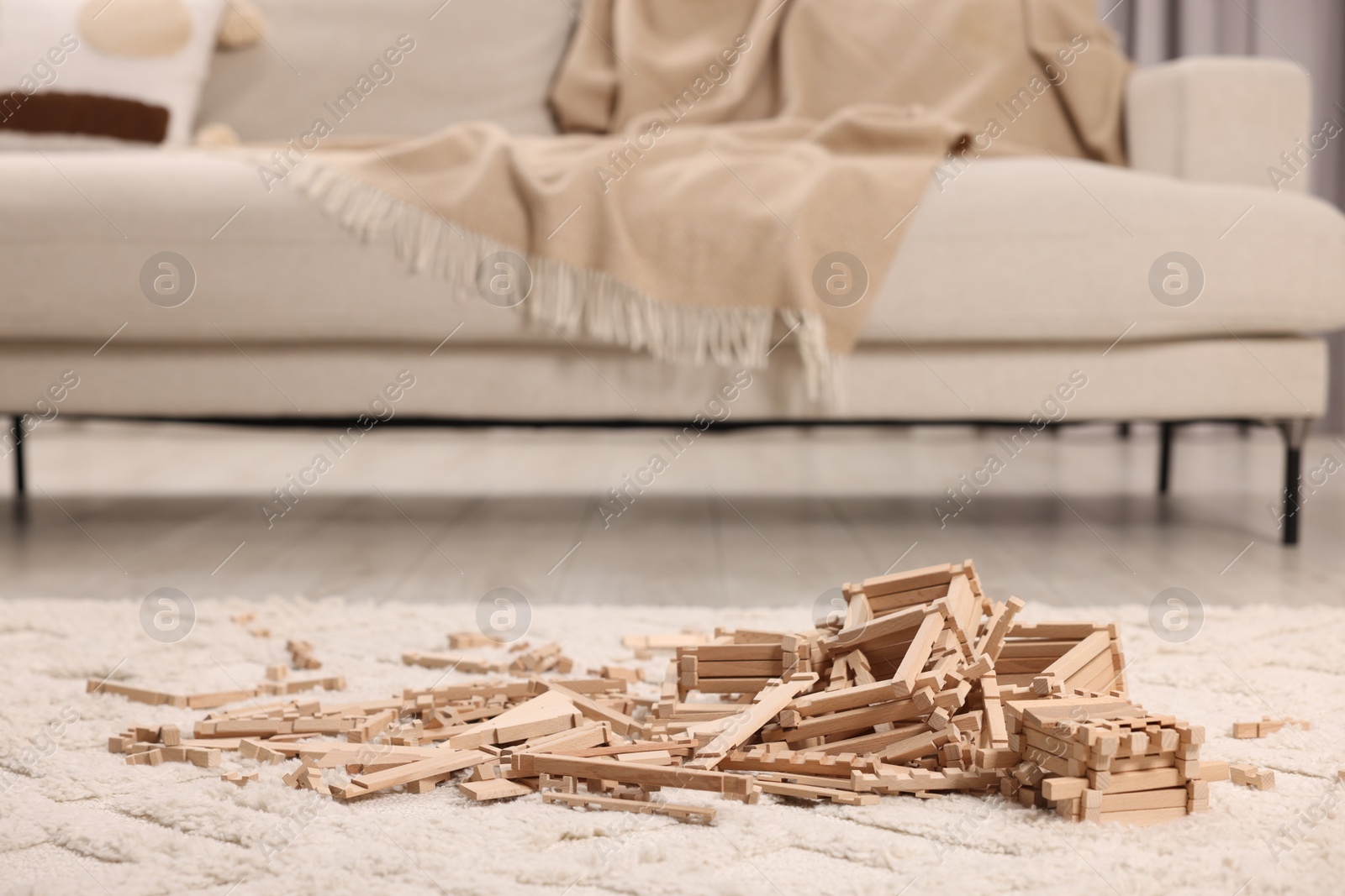 Photo of Wooden construction set on carpet indoors. Children's toy