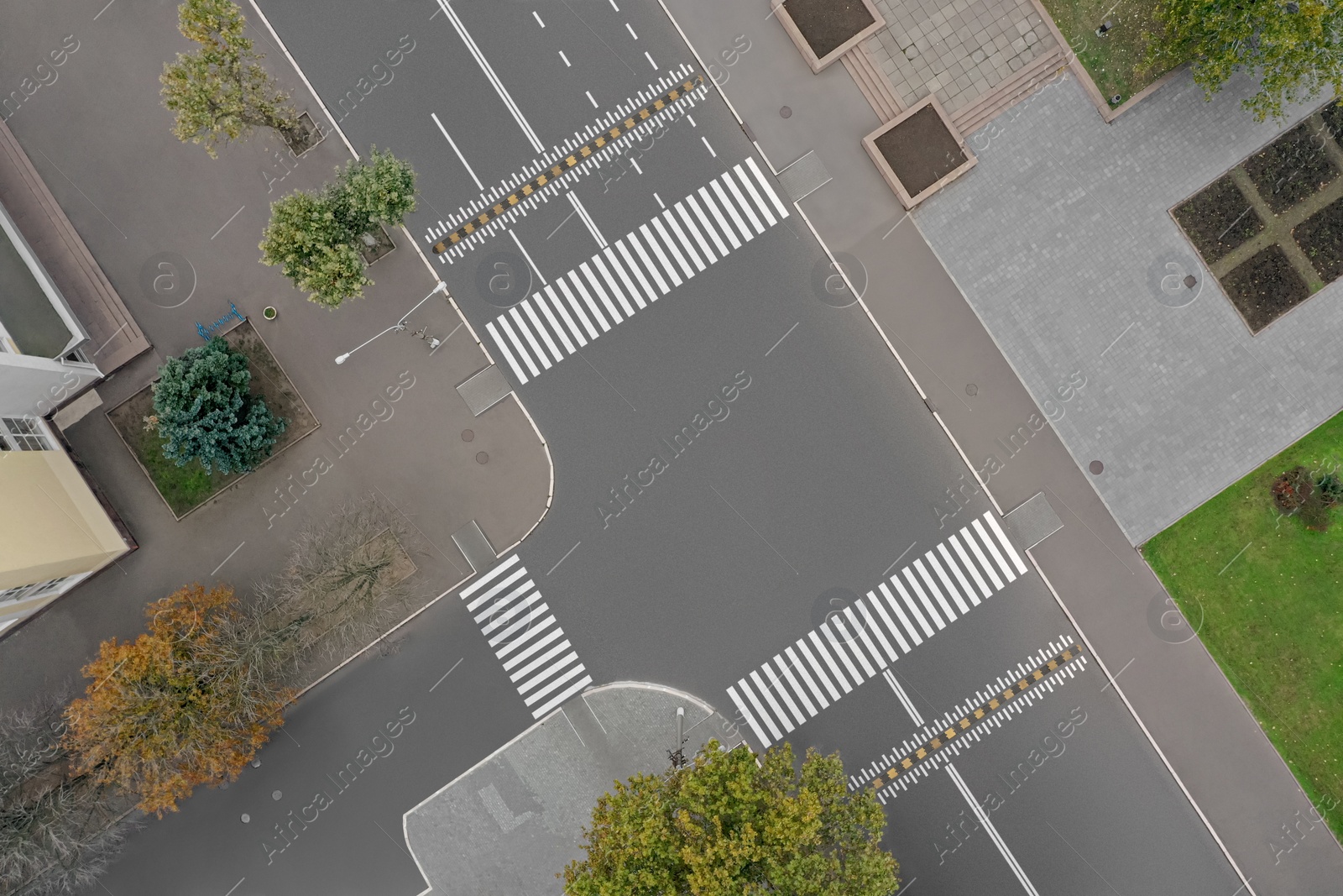 Image of Aerial view of white pedestrian crossings on city street