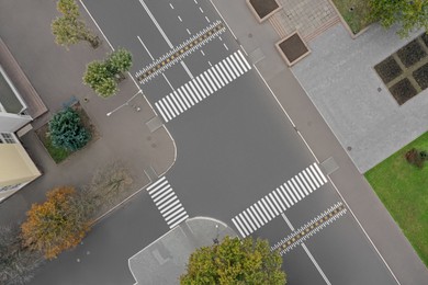 Image of Aerial view of white pedestrian crossings on city street