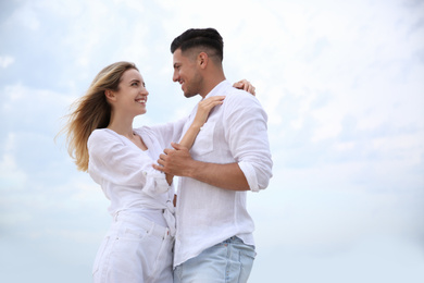 Happy couple on beach, space for text. Romantic walk