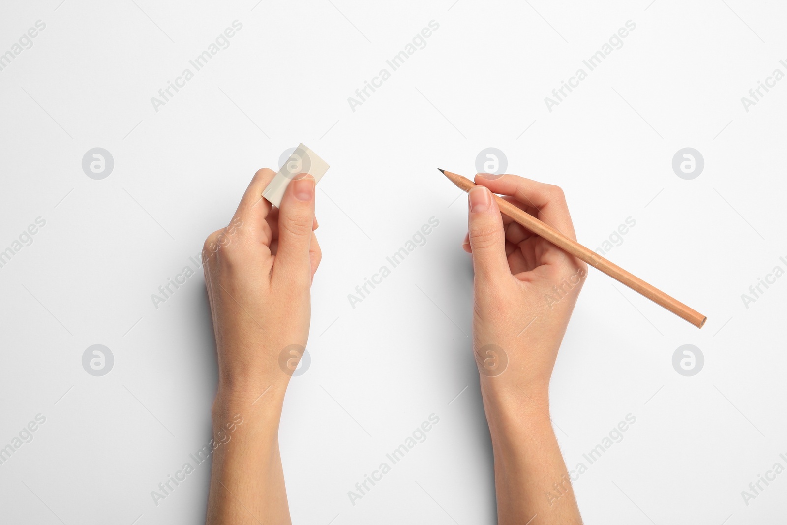 Photo of Woman with graphite pencil and eraser on white background, top view