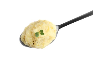 Photo of Spoon of tasty mashed potatoes with microgreen and black pepper isolated on white, top view