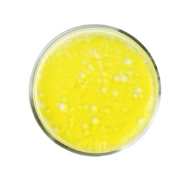 Petri dish with yellow liquid sample on white background, top view