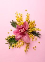 Photo of Beautiful floral composition with mimosa flowers on pink background, flat lay