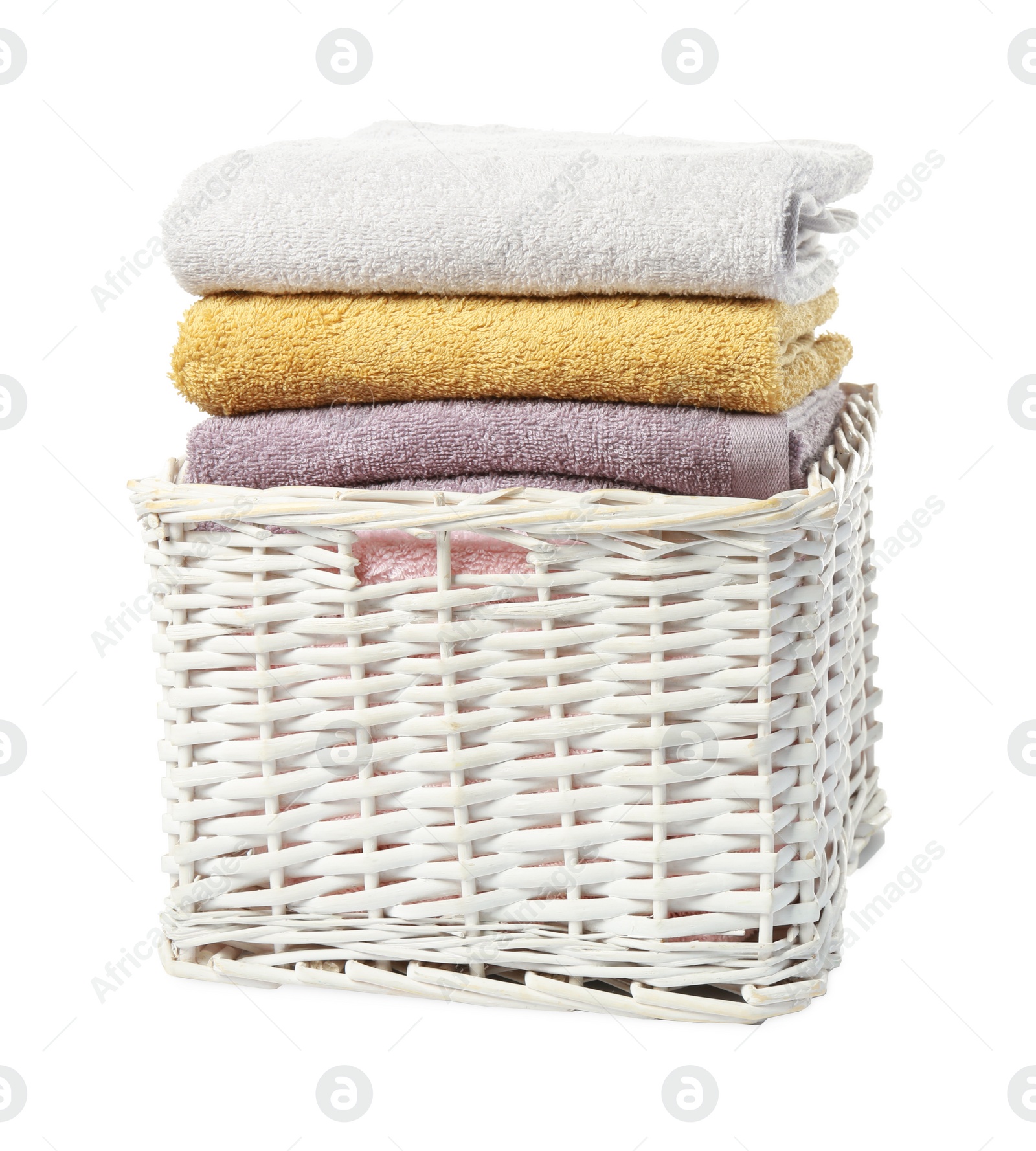 Photo of Wicker laundry basket with folded towels isolated on white