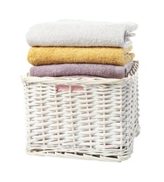 Photo of Wicker laundry basket with folded towels isolated on white
