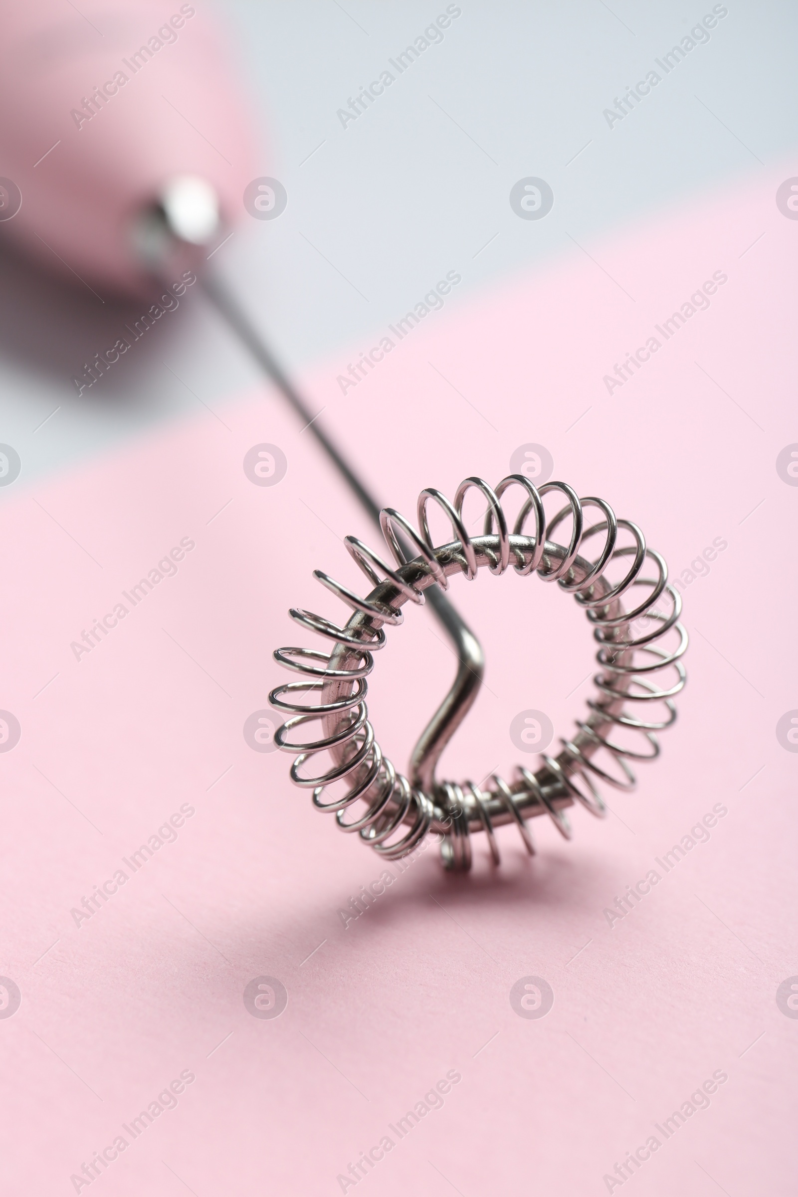 Photo of Pink milk frother wand on color background, closeup