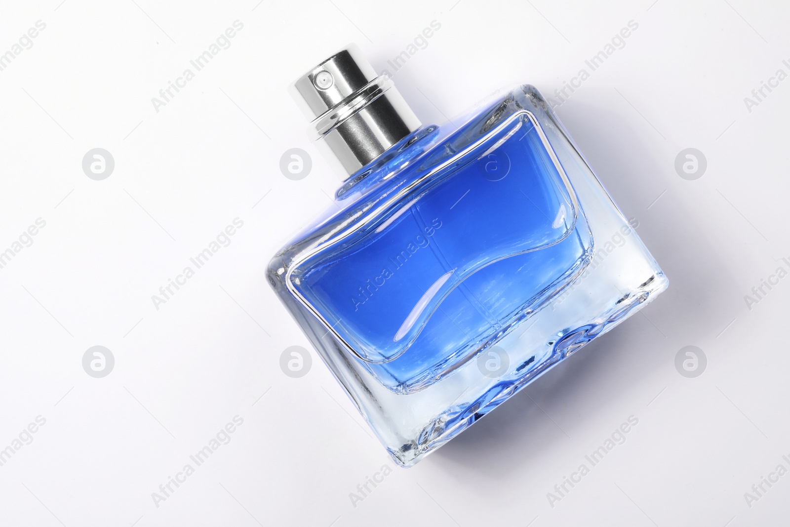 Photo of Blue men's perfume in bottle on white background, top view