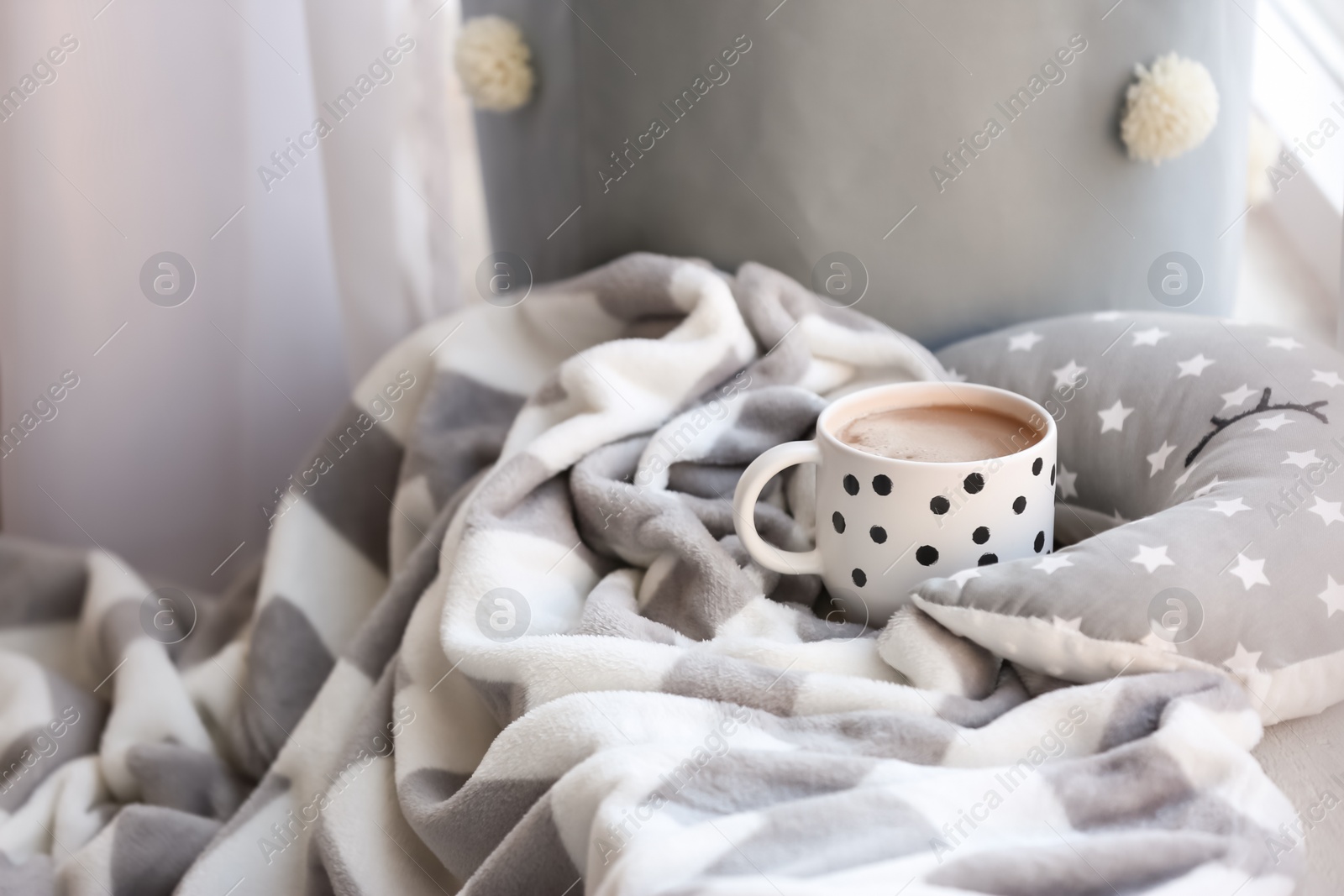 Photo of Cup of coffee and plaid indoors