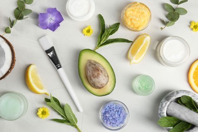 Flat lay composition with homemade cosmetic products and fresh ingredients on light grey background