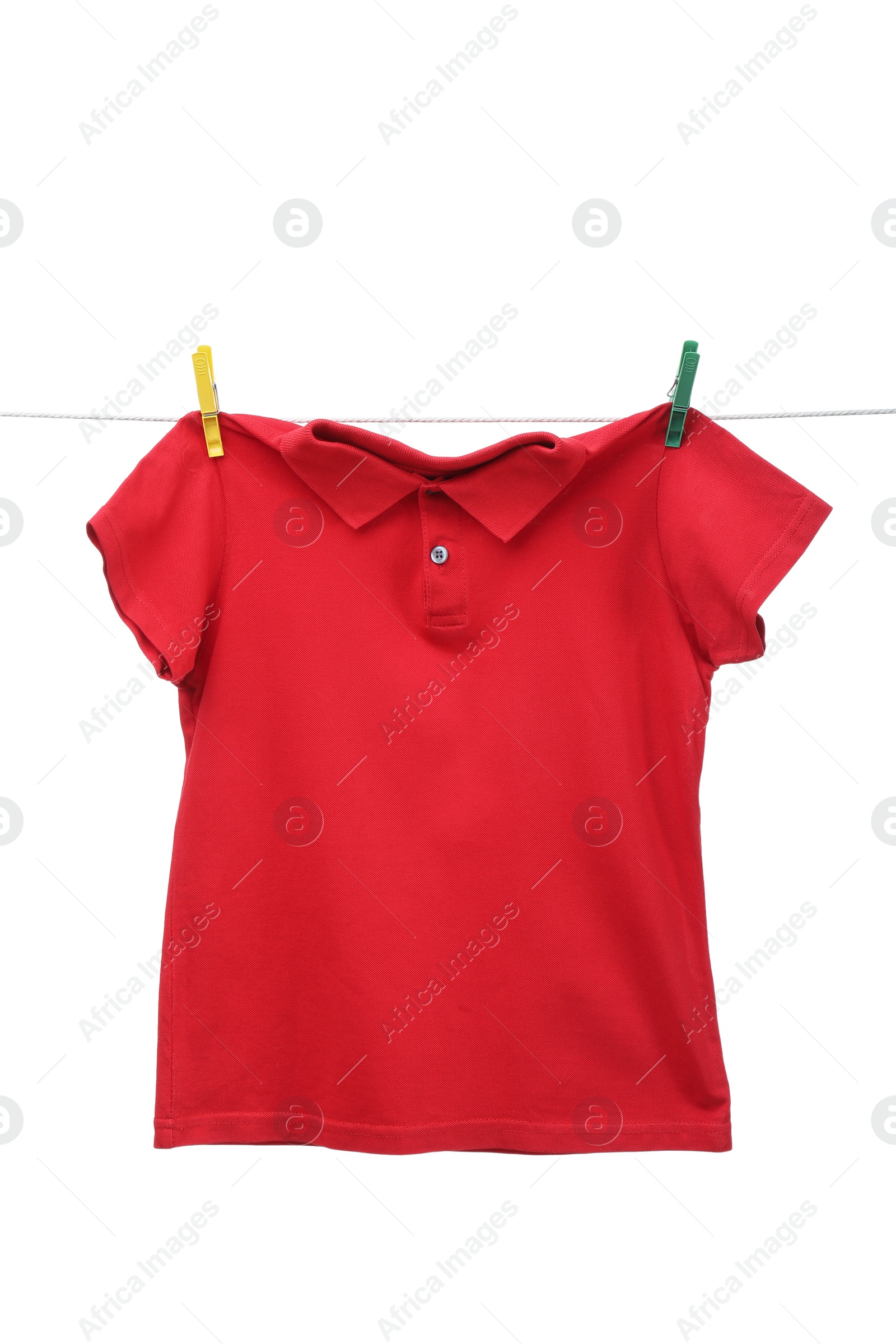 Photo of One red t-shirt drying on washing line isolated on white