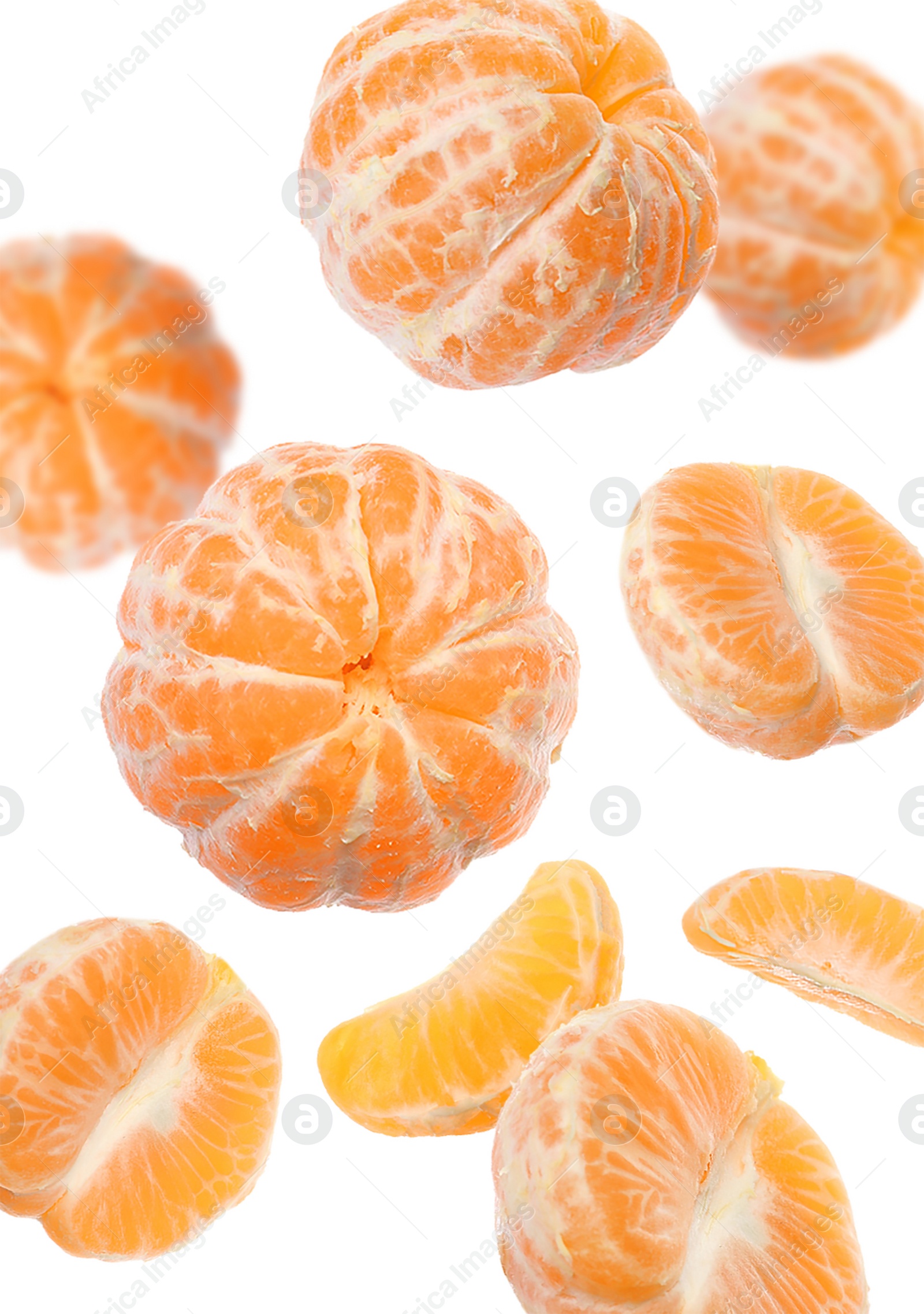 Image of Peeled fresh tangerines falling on white background