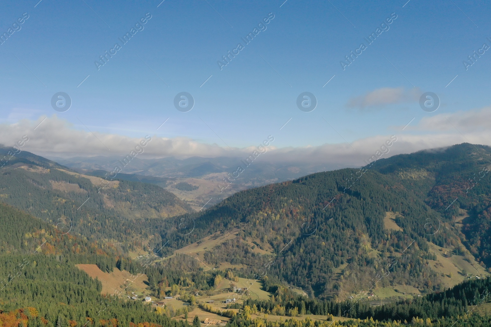 Photo of Aerial view of beautiful mountain forest and village on autumn day