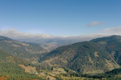 Aerial view of beautiful mountain forest and village on autumn day