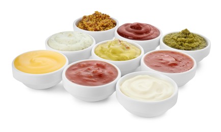 Photo of Many different sauces in bowls on white background