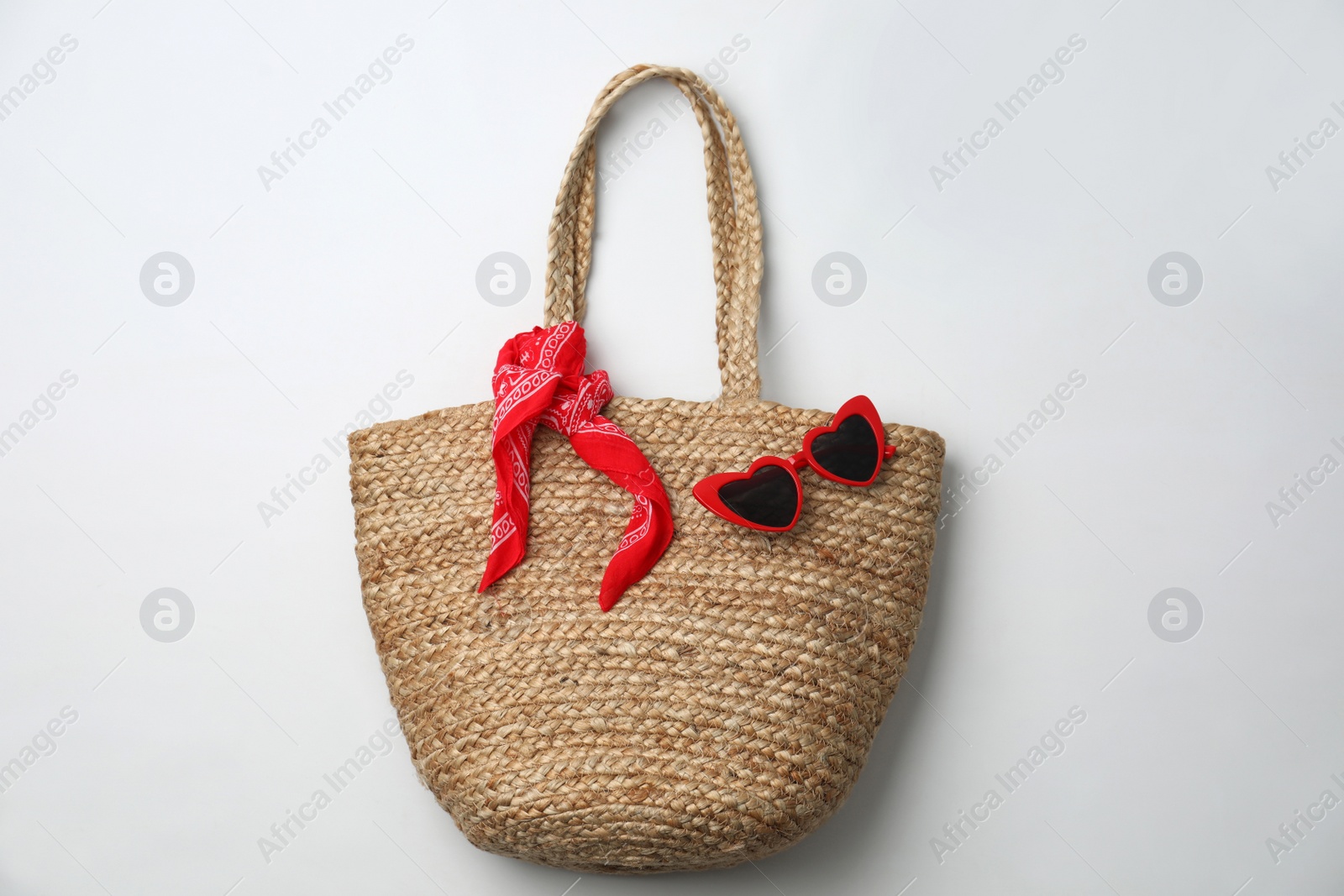 Photo of Stylish straw bag and sunglasses on white background, top view. Summer accessories