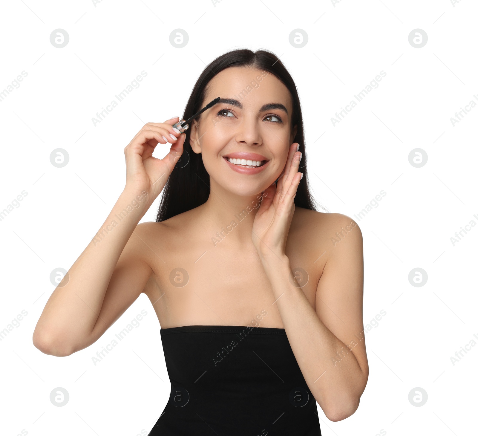 Photo of Beautiful young woman applying mascara on white background