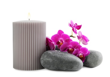 Photo of Orchid with spa stones and candle on white background