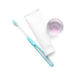 Mouthwash, toothbrush and paste on white background, top view