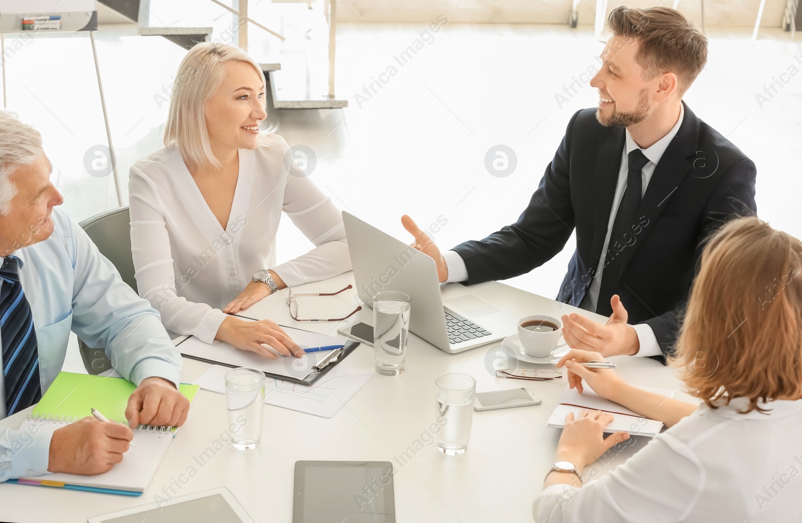 Photo of Group of people discussing ideas at table in office. Consulting service concept