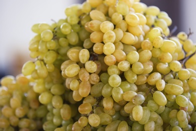 Photo of Fresh ripe juicy grapes on blurred background, closeup