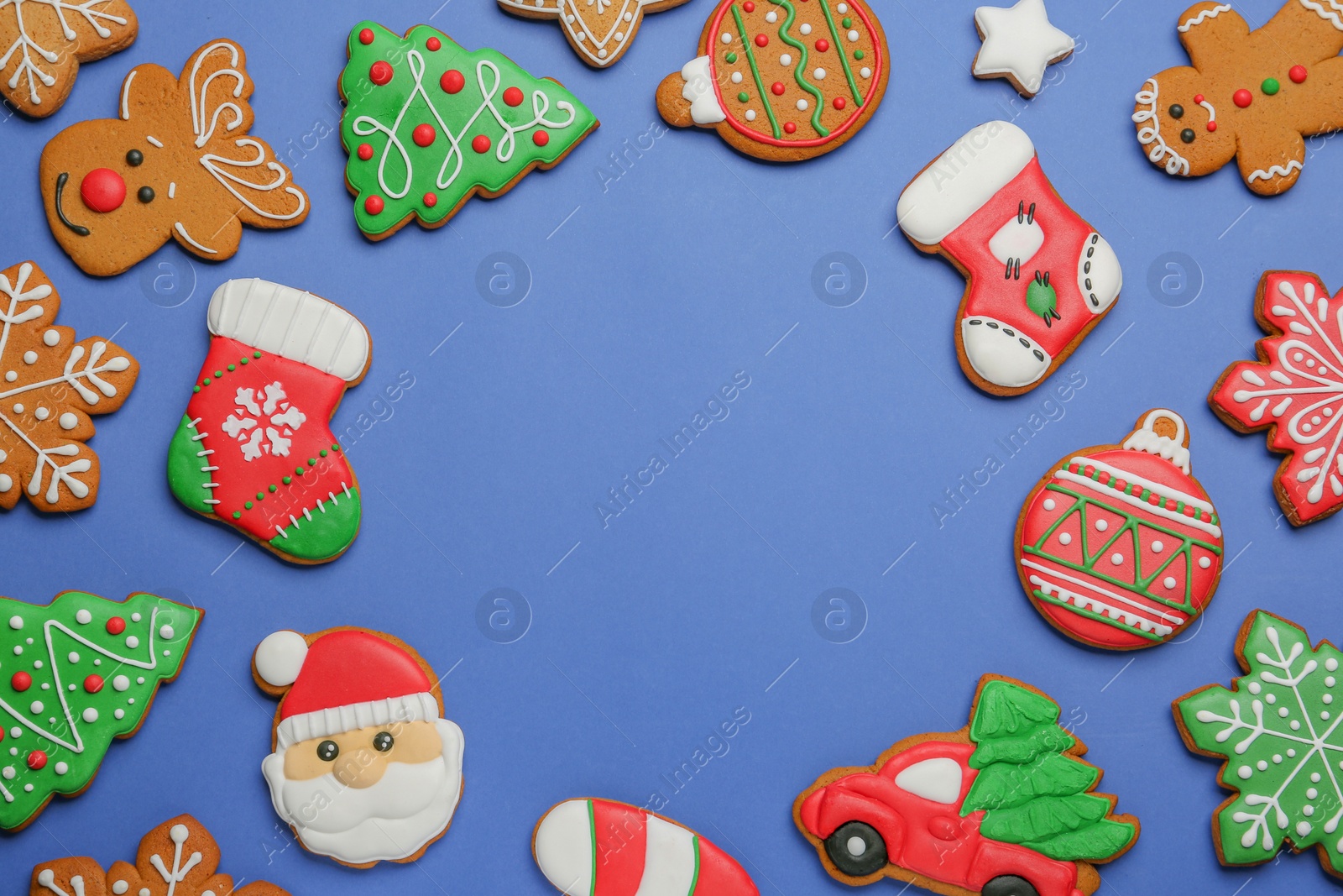 Photo of Different tasty Christmas cookies on blue background, flat lay. Space for text
