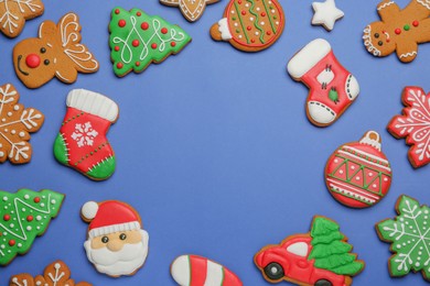 Photo of Different tasty Christmas cookies on blue background, flat lay. Space for text